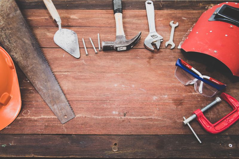 Hand tools arranged on a wooden surface