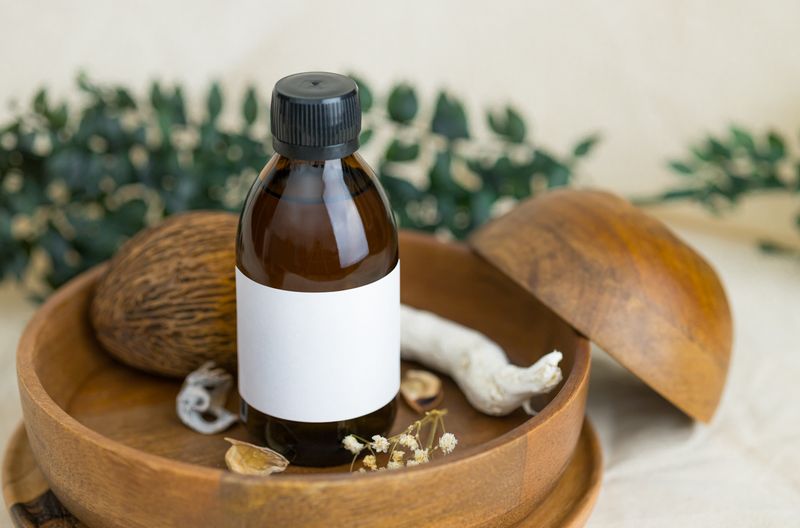 An amber glass bottle with a blank white label