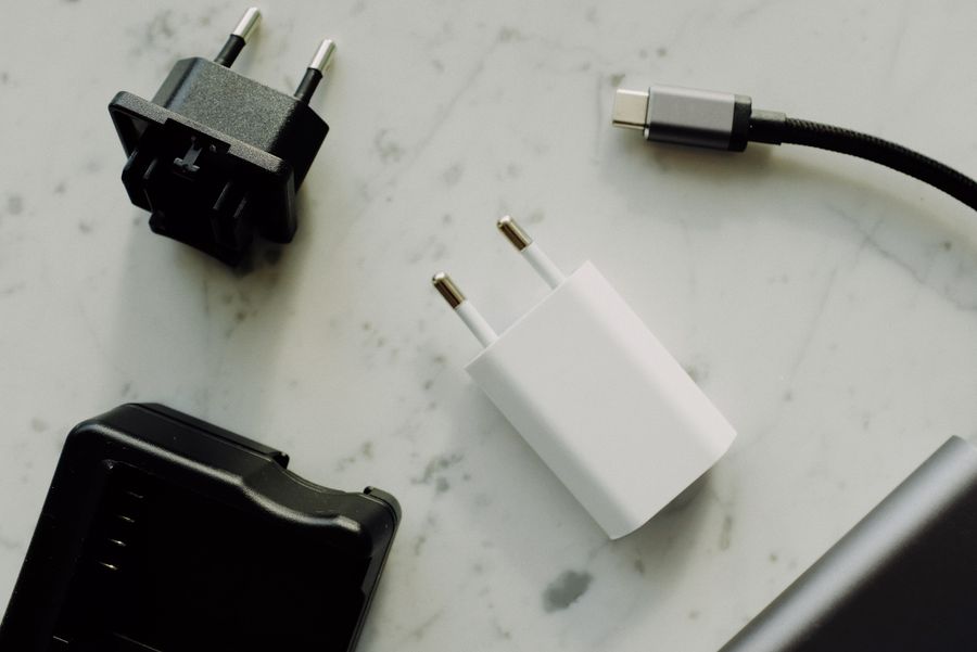 Plug adapters and cable connectors on a light marble surface