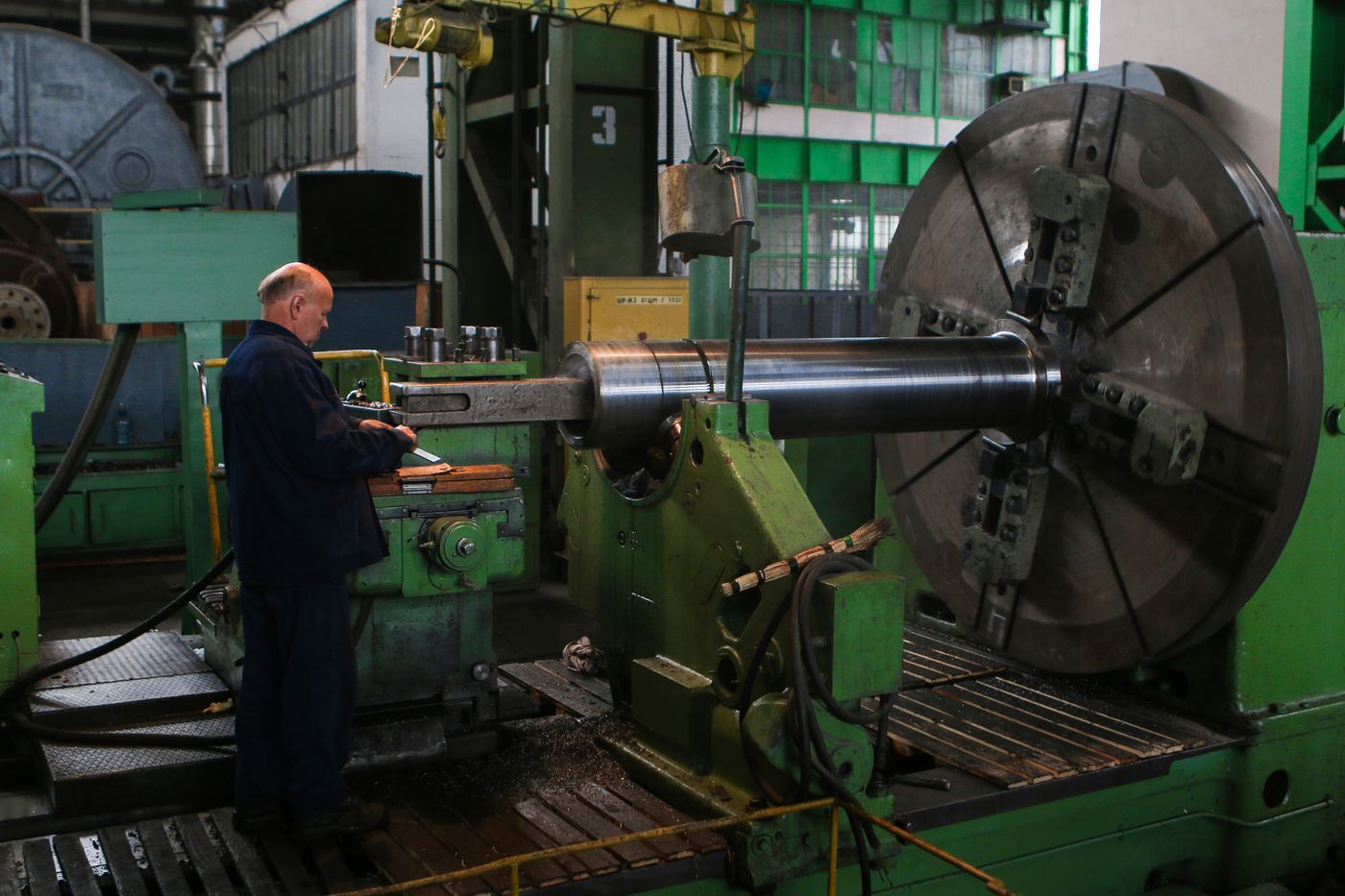 A real worker checking machinery in an industrial plant.