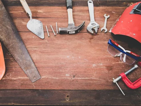 Hand tools arranged on a wooden surface
