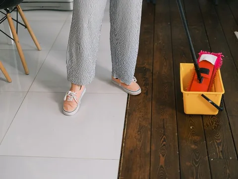 A mop and bucket being used to clean a floor