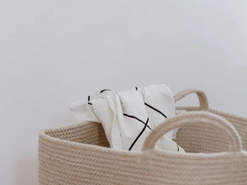 Fabric baskets holding bed linen