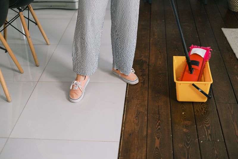 A mop and bucket being used to clean a floor
