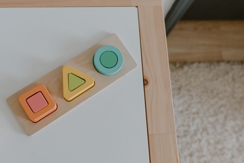 A wooden shape-sorting puzzle