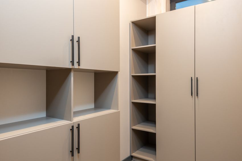 A wooden wardrobe with empty shelves