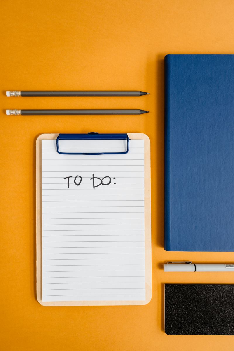 Notebooks and writing supplies on an orange background